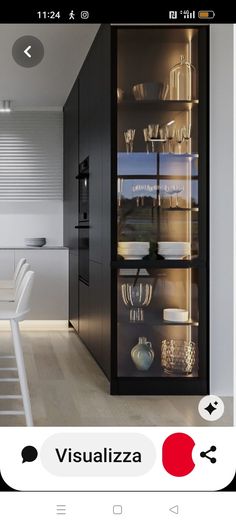 an open cabinet in the middle of a kitchen with white chairs and counter tops on each side