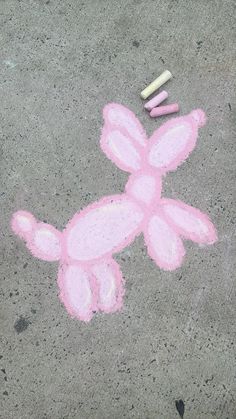 a pink bunny drawn on the ground with crayons