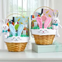 two baskets filled with easter decorations and bunny ears