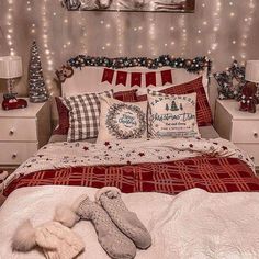 a bedroom decorated for christmas with lights on the wall and bed in the foreground