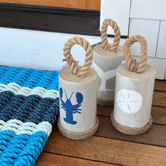 three white and blue containers sitting on top of a wooden floor next to a rug