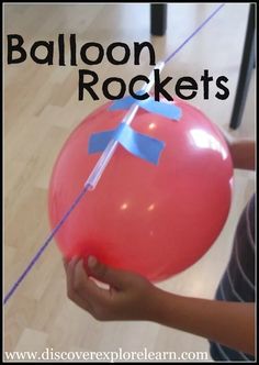 a person holding a red balloon with blue tape on it and the words balloon rockets