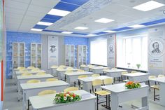 an empty classroom with desks and yellow chairs