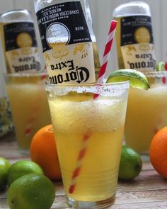 oranges, limes and lemonade are arranged on a table