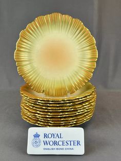 a stack of gold plates sitting on top of each other