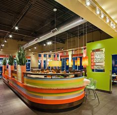 a brightly colored restaurant with tables and chairs