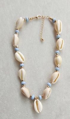 a necklace with seashells and blue beads