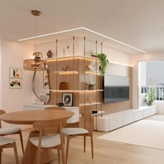 a living room filled with furniture and a flat screen tv mounted on a wall next to a window