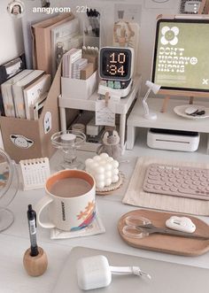 a desk with a computer, keyboard, mouse and other office supplies on it's desk