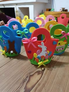 several colorful plastic easter baskets sitting on top of a wooden table