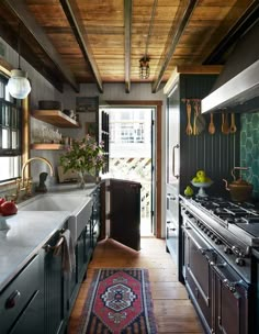 a kitchen with wooden ceilings and stainless steel appliances