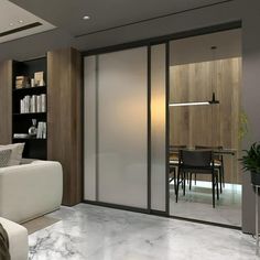 a living room filled with furniture next to a book shelf and a dining room table