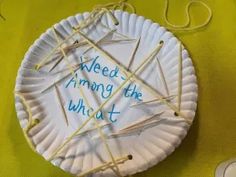 a paper plate that has some knitting needles on it and the words need among the what