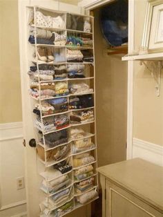 an organized closet in the corner of a room