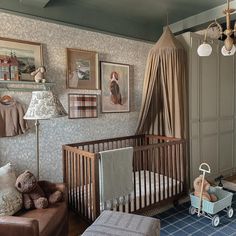 a baby's room with a crib, chair and pictures on the wall