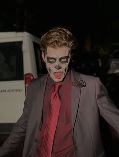 a man in a suit and face paint