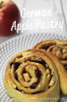 two cinnamon apple pastry on a plate with an apple in the background and text overlay that reads german apple pastry