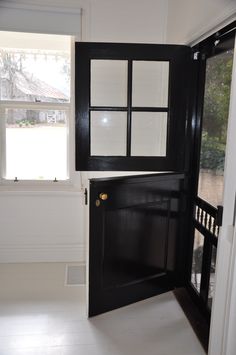 an empty room with black doors and white flooring is pictured in this image from the doorway