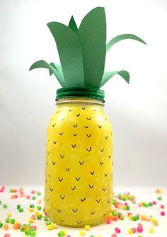 a pineapple painted mason jar with sprinkles