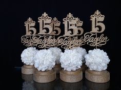 three vases filled with white flowers on top of a table