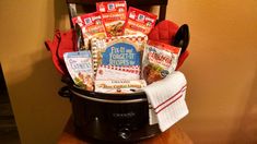 a crock pot filled with lots of goodies on top of a wooden table