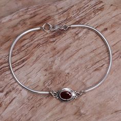 Beams of moonlight accompany a garnet gem creating this elegant bracelet. Wayan Asmana presents the sterling silver design. .925 Sterling silver Sterling Silver Bangle Bracelets, Garnet Pendant, Nail Jewelry, Silver Bangle Bracelets, Sterling Silver Bangles