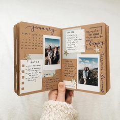 a person holding an open book with pictures on it and writing on the pages, in front of a white background