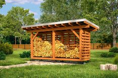 a small wooden shelter with logs stacked on top of it in the middle of a grassy area