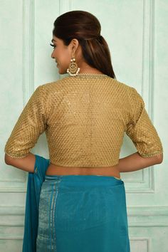 Gold net princess cut padded blouse with all over sequin work, plunged V neck and lace embellishment.
Component: 1
Pattern: Embroidered
Type Of Work: Sequin Work
Neckline: Plunged V Neck
Sleeve Type: Half Sleeves
Fabric: Net
Color: Gold
Other Details: 
Side zip closure
Note: The saree worn by the model is not sale
Occasion: Sangeet,Cocktail - Aza Fashions Padded Blouse, Gold Blouse, Saree Blouses, Blouse For Women, Buy Gold, Blouse Online, Gold Sequin, V Neck Blouse, Work Blouse