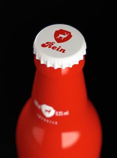 a red soda bottle with a white cap