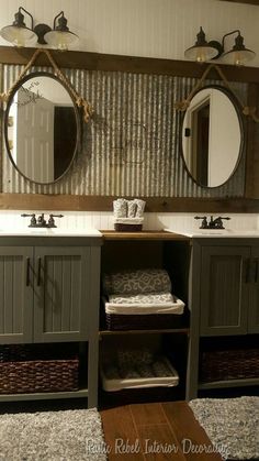 a bathroom with two sinks and mirrors above the sink, along with baskets on the floor