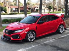 a red sports car parked on the side of the road