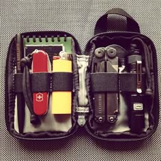 an open tool bag with tools in it