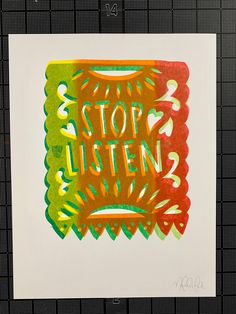 an art print with the words stop listen written in orange, green and red ink