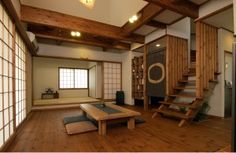 a living room with wooden floors and stairs