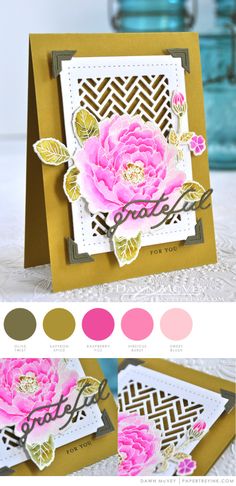 a close up of a card with a pink flower on the front and gold trimmings