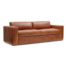 a brown leather couch sitting on top of a white floor