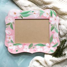 a pink frame with white flowers on it