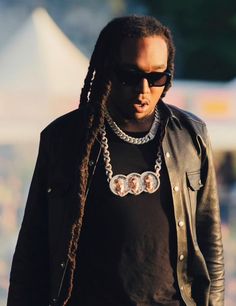 a man with dreadlocks walking down the street