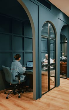 a person sitting at a desk with a laptop in front of them on a chair