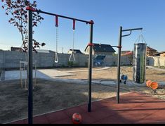 an empty playground with swings and other equipment