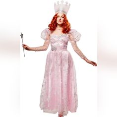 a woman in a pink dress holding a wand