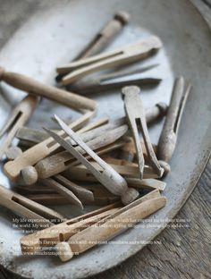 a bunch of wooden clothes pins on a plate