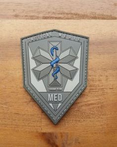 a medical emblem on a wooden surface