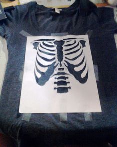 there is a stencil that has a skeleton on it in the shape of a man's chest