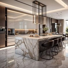 a large kitchen with marble counter tops and bar stools in front of the island