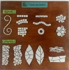 a wooden board with different types of leaves and shapes on it, including the letter s