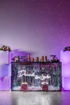 an image of a stage set up with lights and flowers on the back wall in front of it