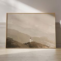 an empty room with a large painting on the wall and a wooden floor in front of it