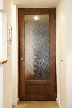 a wooden door with frosted glass on it